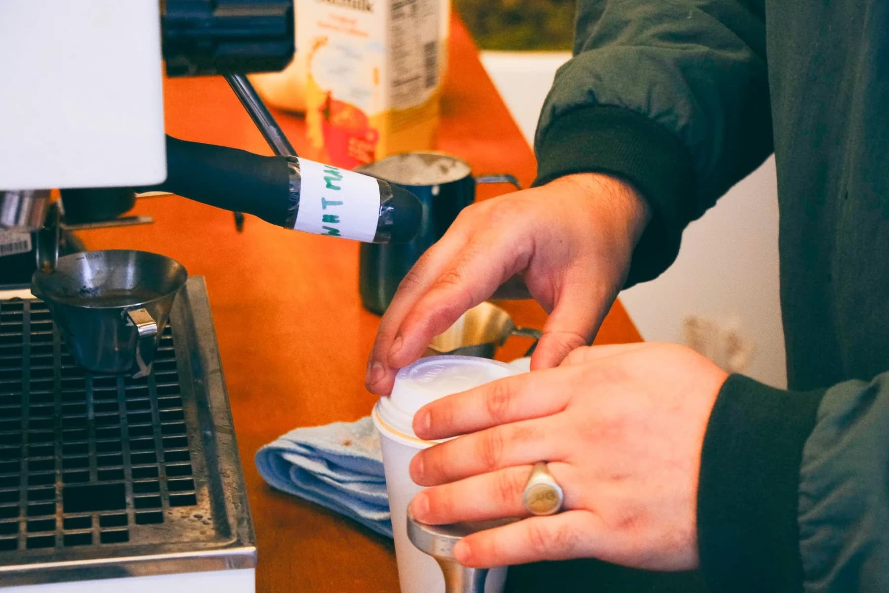 Barista Placing Lid on Coffee Cup at Hines Coffee Event