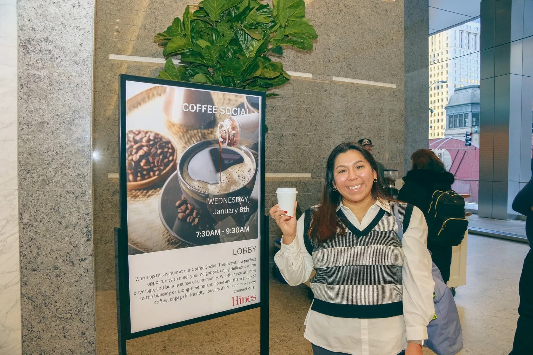 Woman holding coffee smiling wide shot