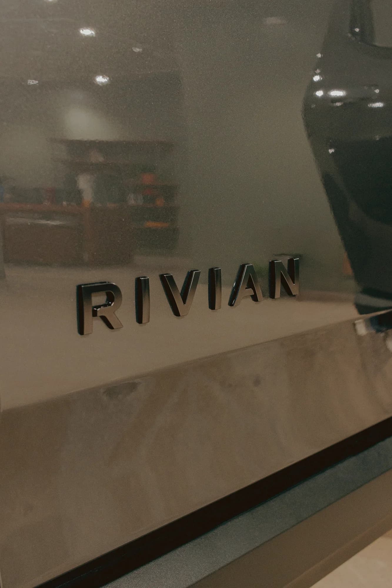 Close-up of the Rivian badge on a vehicle at the Chicago showroom
